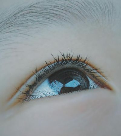 Close-up view of eyes looking towards a window with natural light.